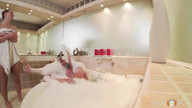 Soapy feetjob by a blonde with the cuttest tits